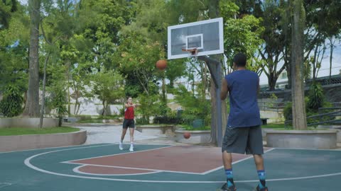 Couple playing basketball