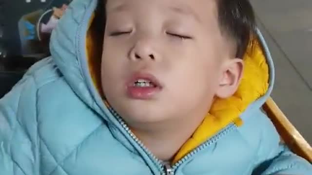 A cute baby who fell asleep on a cart.