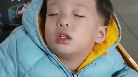 A cute baby who fell asleep on a cart.