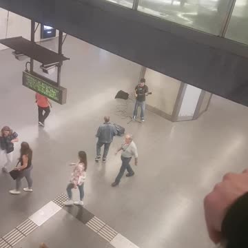 Jean jacket guy dances to guitarist in subway