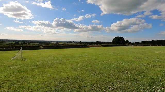 On field on sunny and cloudy day in Cumbria.