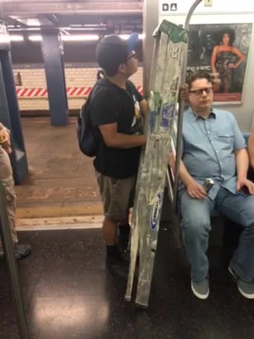 Man carrying dirty ladder on train