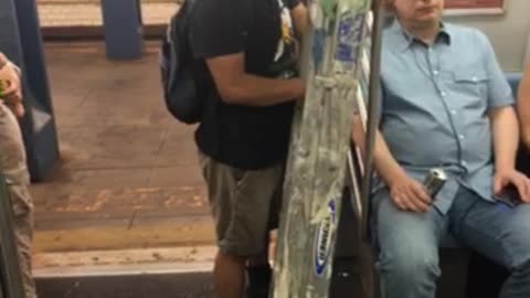 Man carrying dirty ladder on train
