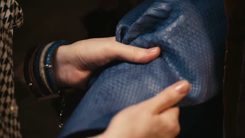 hands touching the leather of a python snake