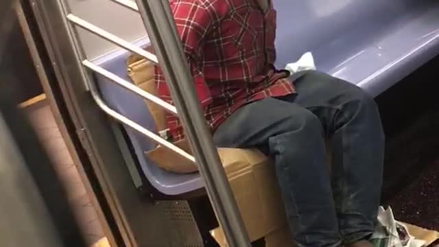 Headless red shirt guy rides subway someone takes picture of him