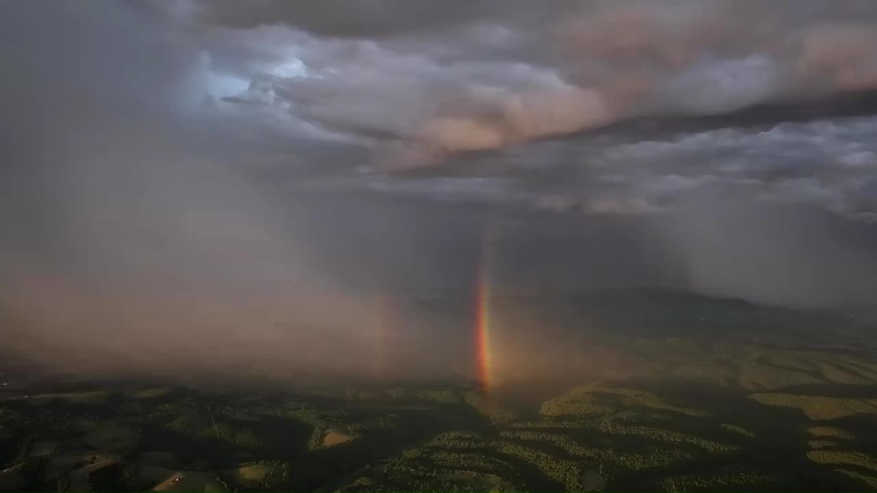 Mavik 3 Pro Capturing a double rainbow inside a distant rain storm along with the sunrise