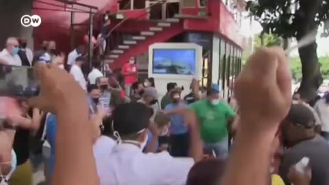 Cubans protest in the streets against Communist regime.