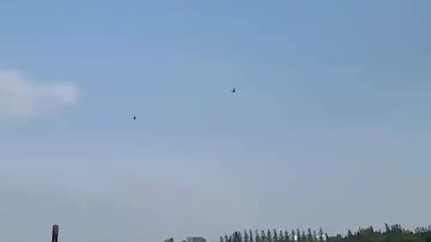 Military helicopters fly over during lunch