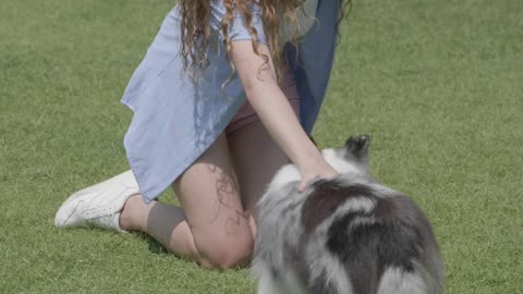 A woman petting her dog, part 1