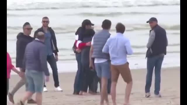 Macron and his wife take a walk by the sea the day before the French election