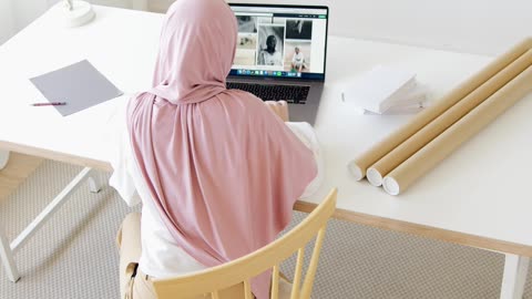 high-angle-shot-of-woman-in-hijab-using-her-laptop