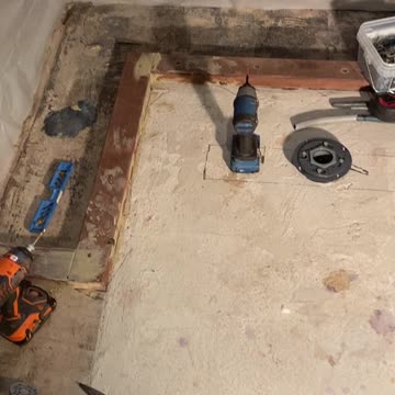 Hanging pressure treated 2x4 for back wall of shower bench