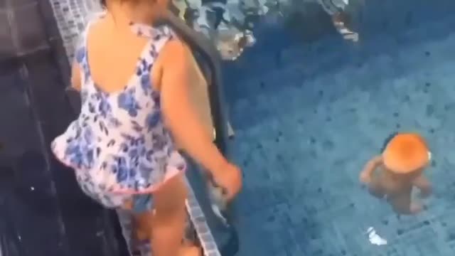 A little girl saved the doll by jumping into the swimming pool.