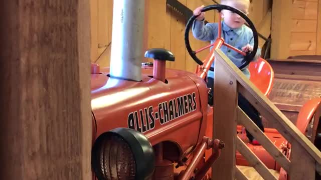 Little patriot rides tractor