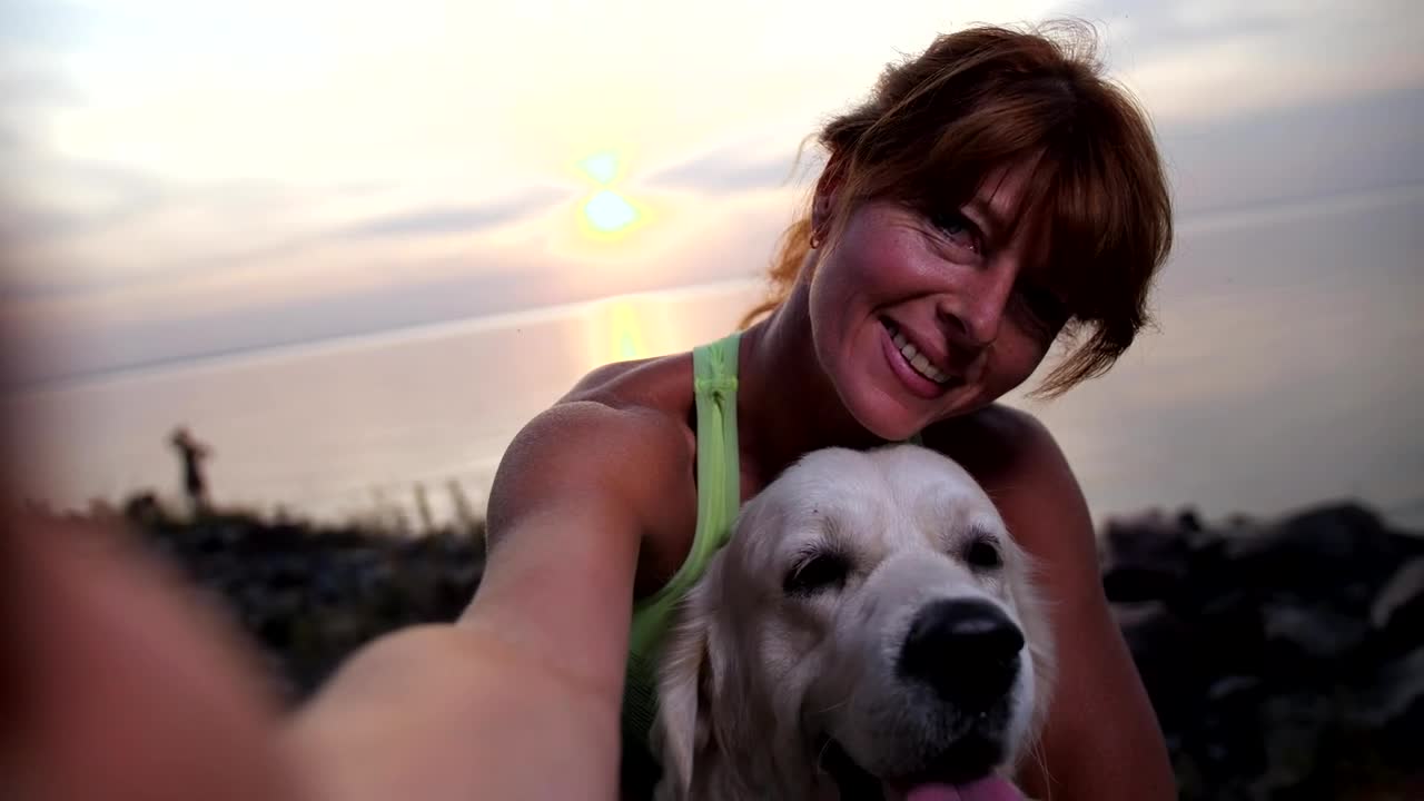 Taking a photo with her dog