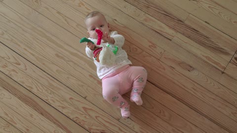 Baby girl holding a soft toy