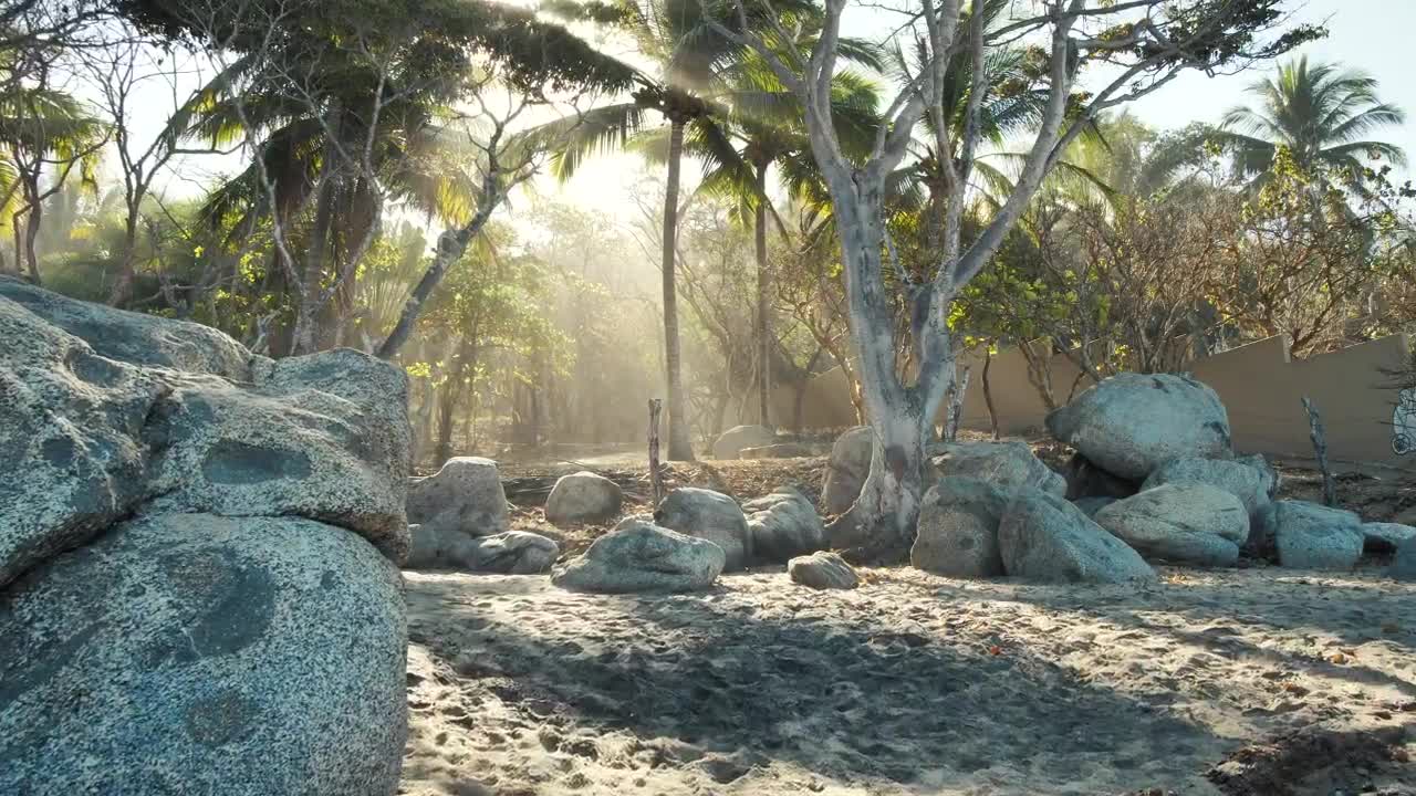 Woman walking slowly through rocks on a beach