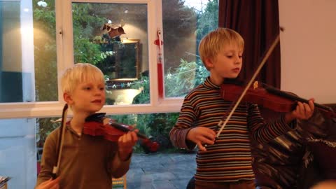 Kids Play Violin And Their Father Teaches Them
