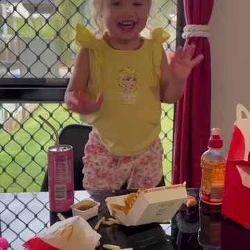 Happy girl dancing over McDonalds