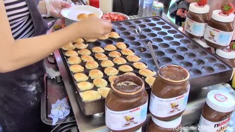 London Street Food. Cooking Sweet Dutch Pancakes "poffertjes" in Camden Lock Market