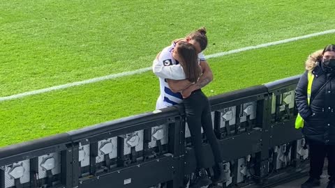 Professional Soccer Player Hugs Daughter During Game