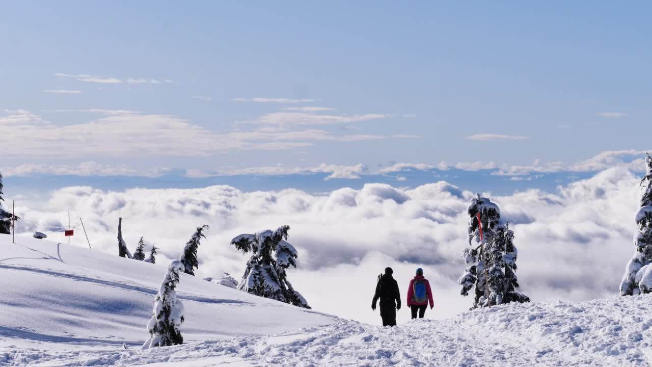 People walking on the snowy summit