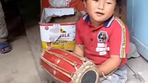 Smal Boy Playing Madal Wtih Singing