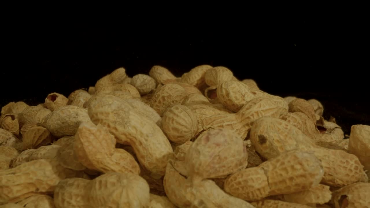 Pile of peanuts on a black background