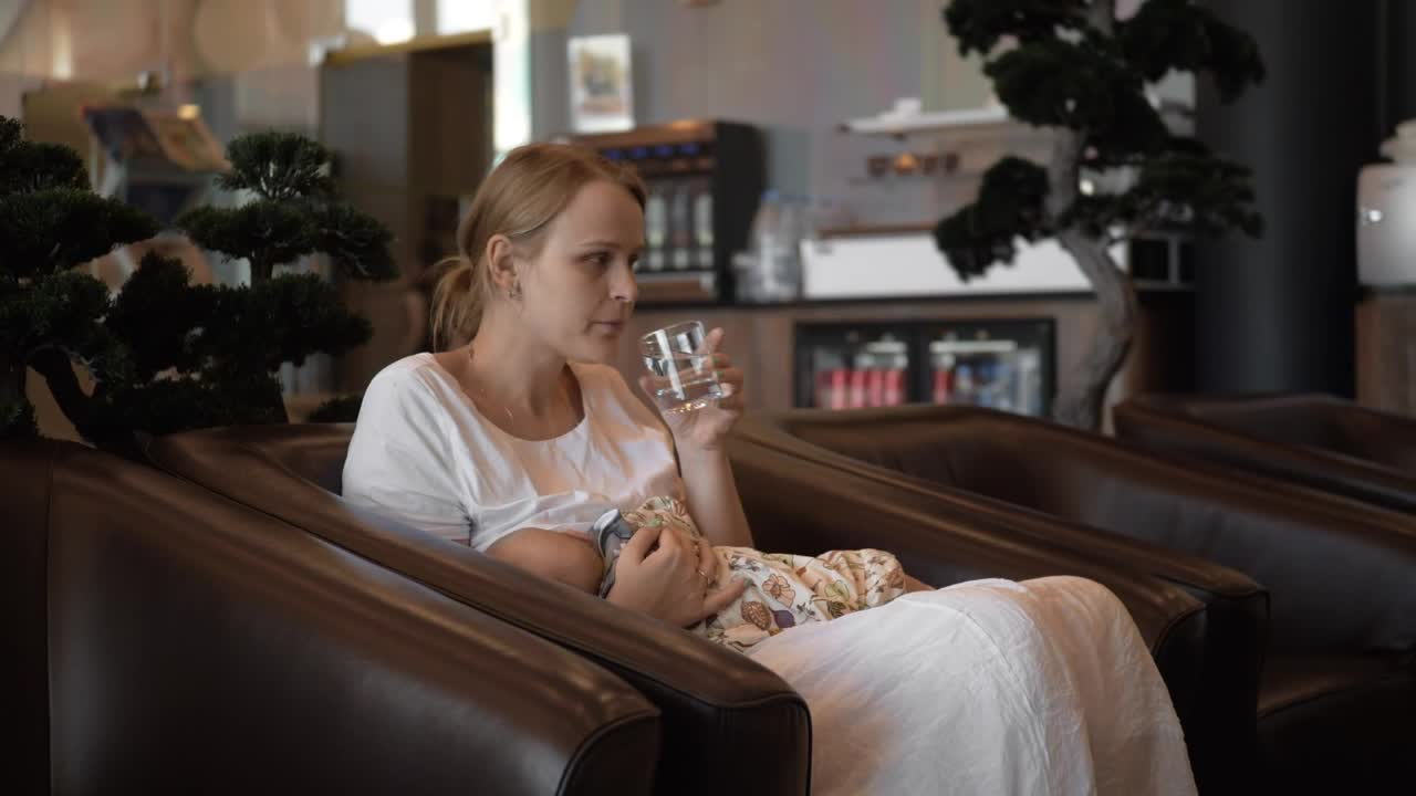 Mother breastfeeding her baby in a hotel