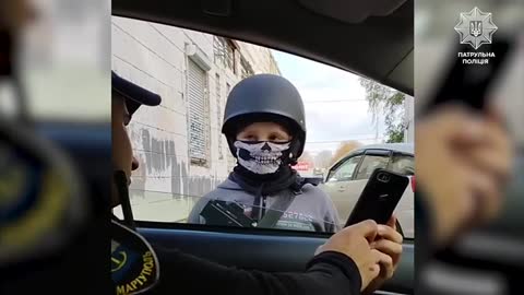 Young child with Ukraine military helmet and gun
