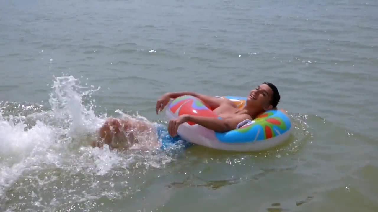 A Young Man Swim Backward on Floaty