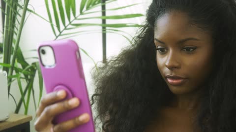 Sexy brown girl watching her phone