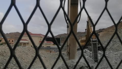 Excavator working in mountain