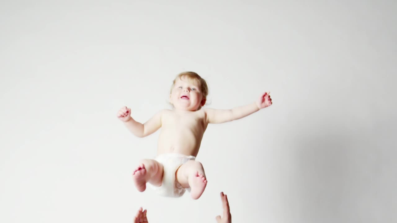 Young baby being thrown by a parent