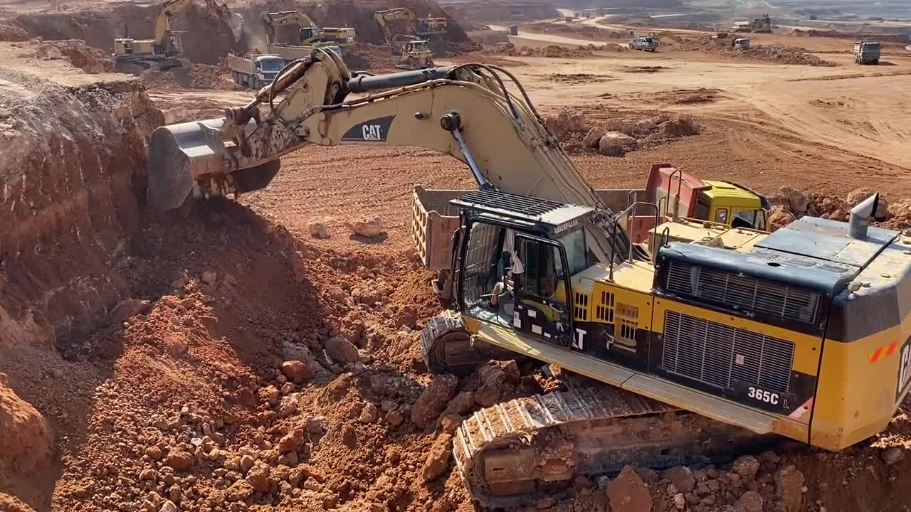 Caterpillar 365C Excavator Loading Trucks