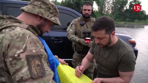 Zelenskiy visits troops, meets people at gas station in east Ukraine