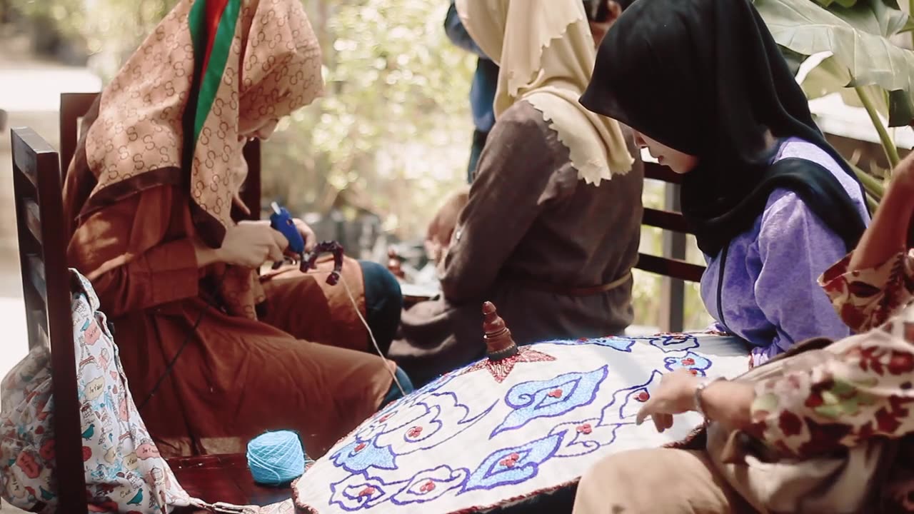 Adorable youngs Muslim girls working to make an ombrella