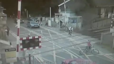 Shocking CCTV_ Cyclist narrowly avoids being hit by train at level crossing