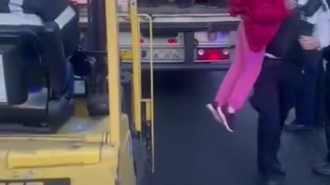 Children being removed from truck trailer.