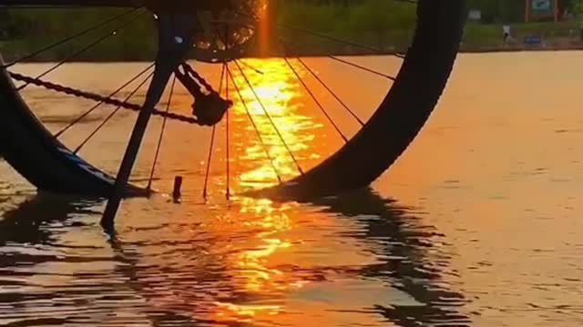 bicycle in the creek at sunset