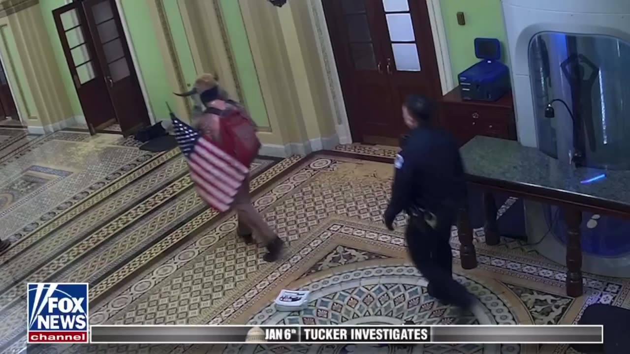 Tucker Carlson shows the Capitol Police escorting the “QAnon Shaman”