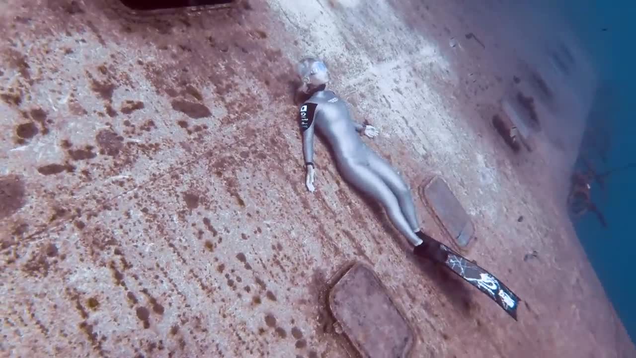 Two world record holding freedivers explore a deep wreck