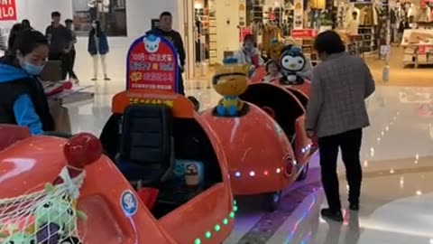 Our daughter goes for a ride on a train in the mall
