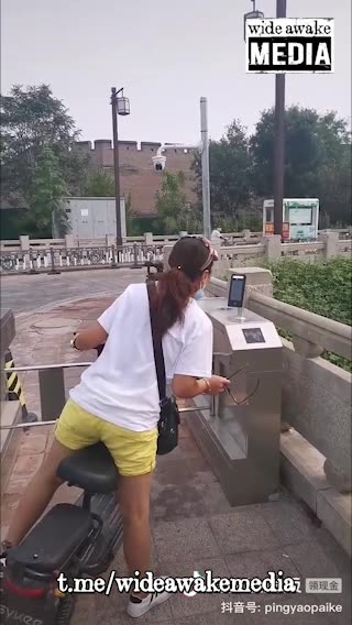 China, citizens go through security barrier to be able to enter their own neighbourhoods.
