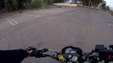 Girl doing wheelies on mini bike