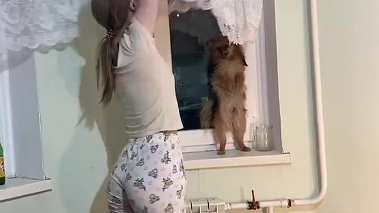 this woman wanted to reach the curtains but did not reach