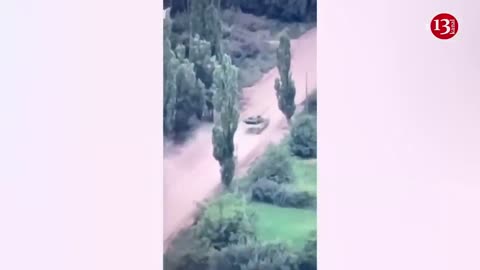 A moving Russian tank is hit - Crew members seek to escape by getting out