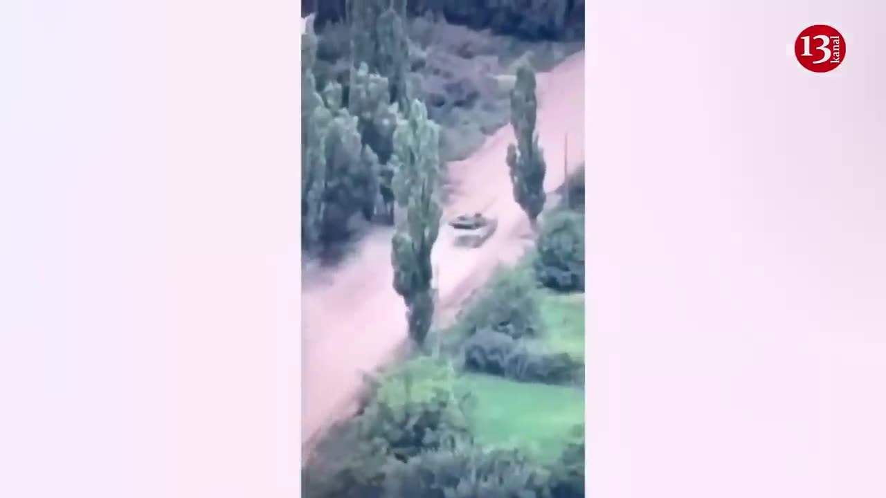 A moving Russian tank is hit - Crew members seek to escape by getting out