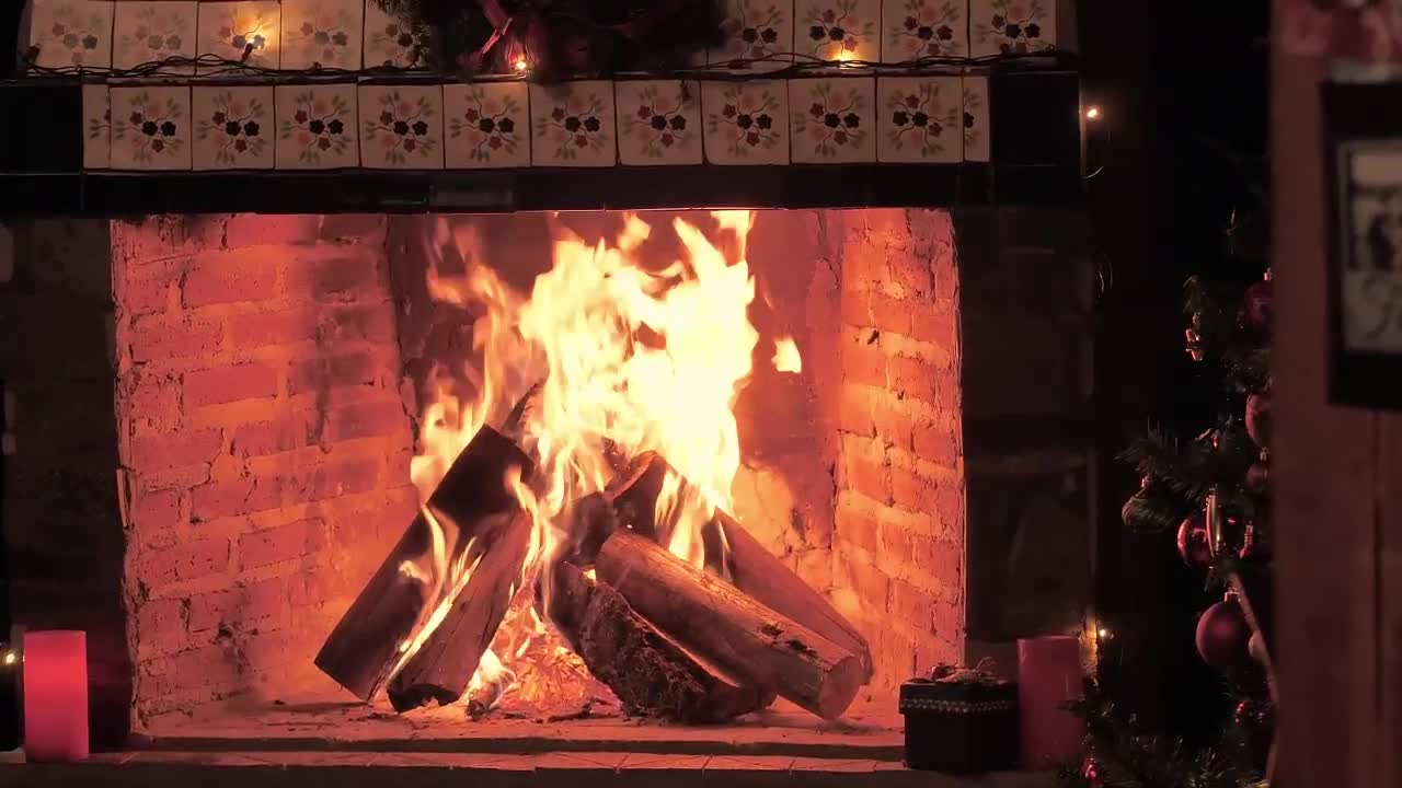 A fireplace lit at Christmas time