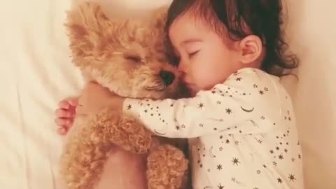 The baby sleeps with the dog